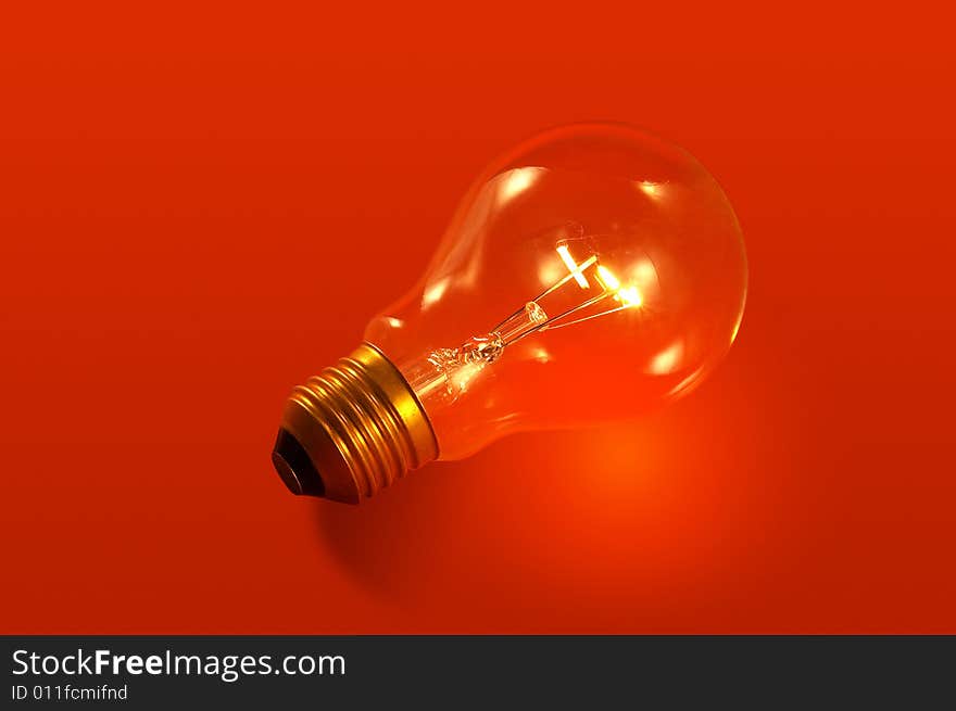 A bulb light on red background. A bulb light on red background