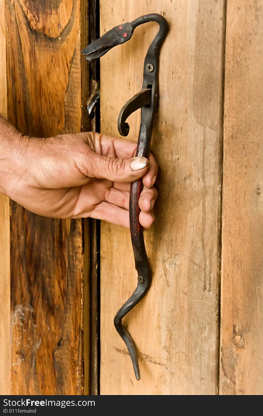 A hand on the door handle.