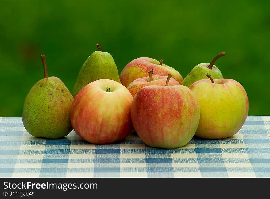 Fresh green apples and pears on table-cloth. Fresh green apples and pears on table-cloth