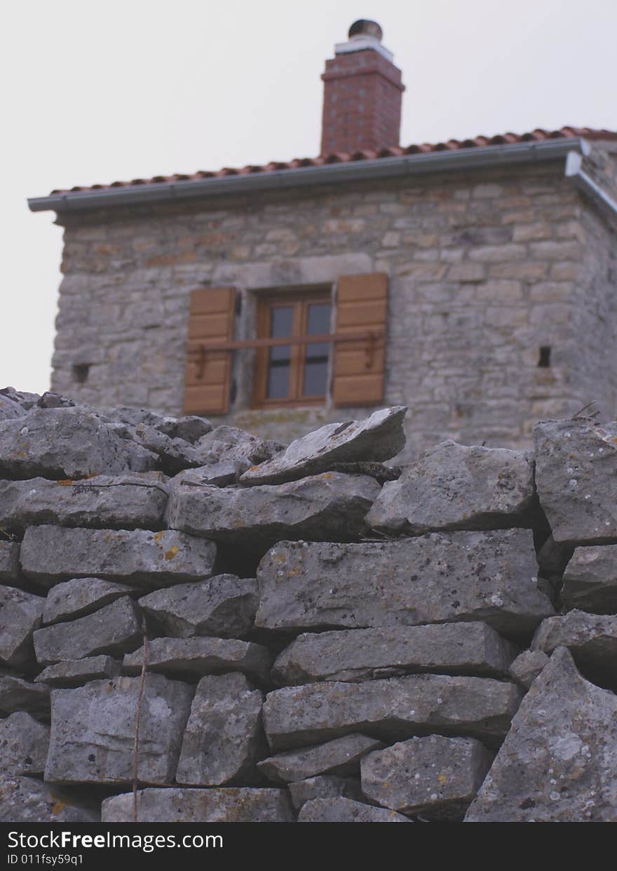 Countryside, rustic stone wall and house at dusk. Countryside, rustic stone wall and house at dusk