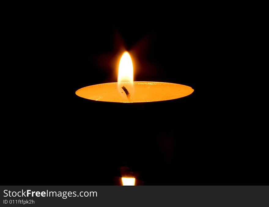 Candle isolated on black background