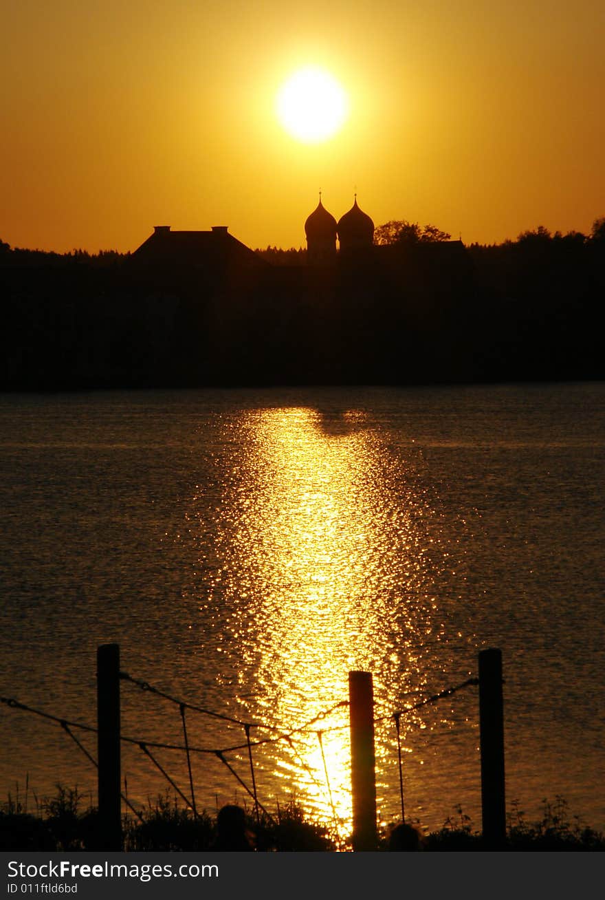 Evening sun above Old Monastery with Church on Seeon lake in  South Bavaria .  Not so far from Traunstein City and Chiemsee lake. Evening sun above Old Monastery with Church on Seeon lake in  South Bavaria .  Not so far from Traunstein City and Chiemsee lake.