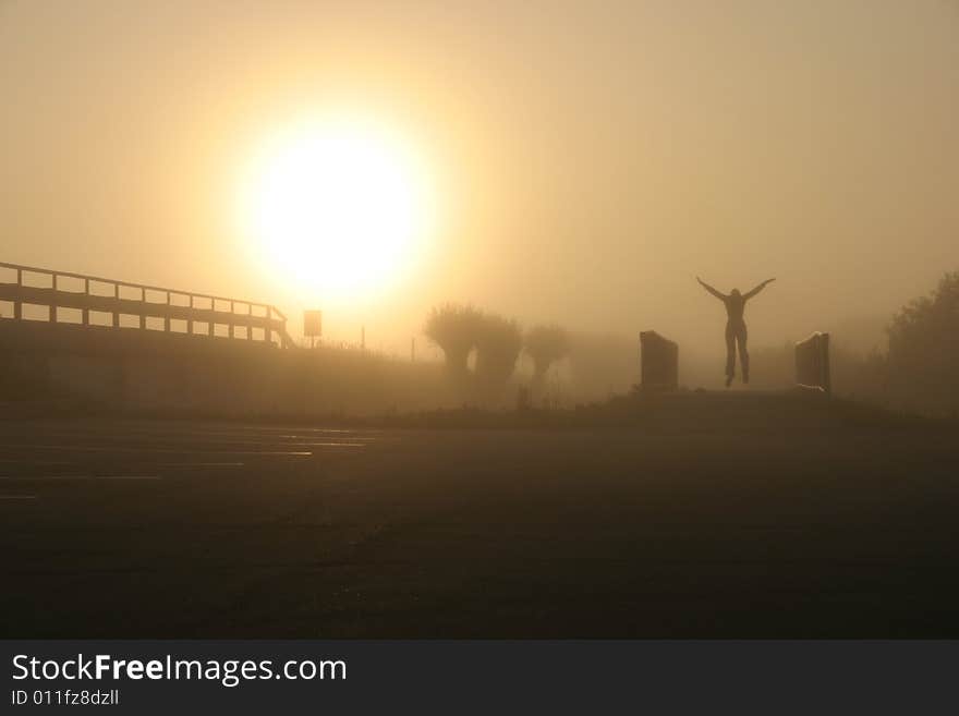 Morning jump on the bicycle bridge by a foggy field. Morning jump on the bicycle bridge by a foggy field