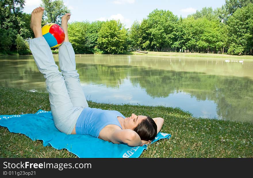 Girl Enjoying some exercises with ball outdoors