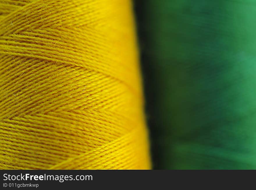 Spool of the coloured threads Macro: green and yellow. Spool of the coloured threads Macro: green and yellow