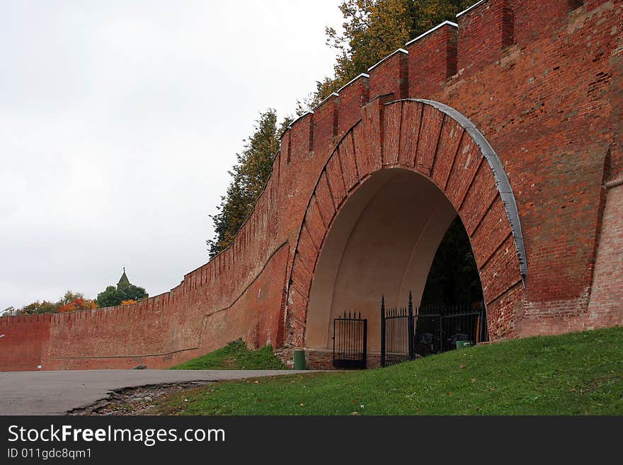 A big wall from red brick with gates. A big wall from red brick with gates