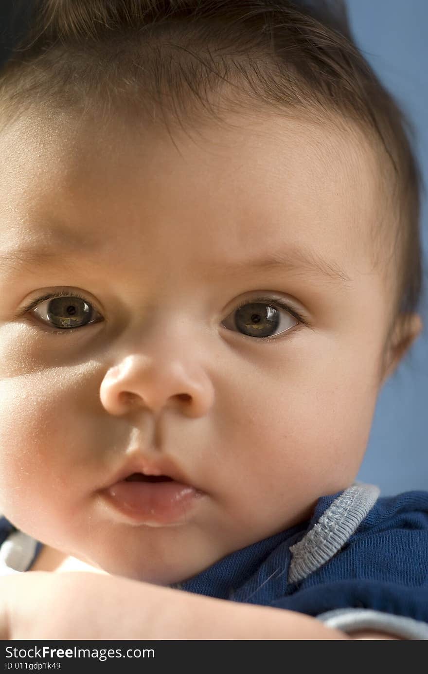 Cute close up of dark-haired baby. Extremely shallow depth of field, focus on right eye. 6months. Cute close up of dark-haired baby. Extremely shallow depth of field, focus on right eye. 6months