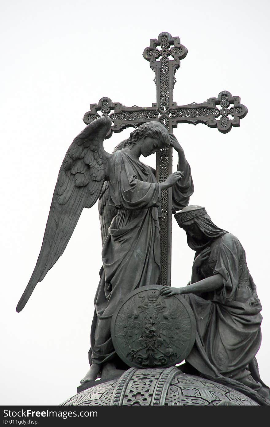 A part of a monument with angel and cross. A part of a monument with angel and cross