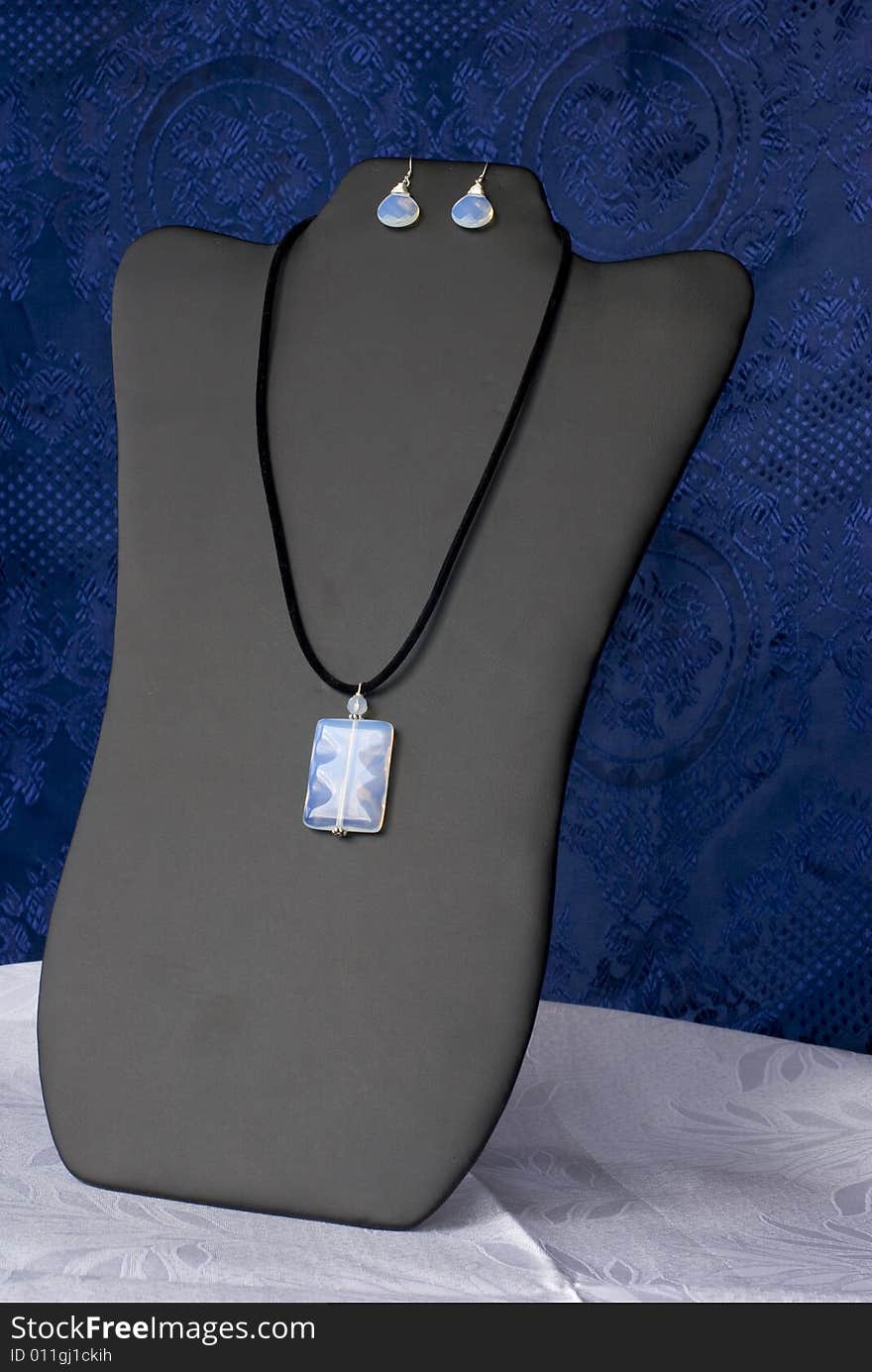 A luxury necklace on a blue background. A luxury necklace on a blue background.