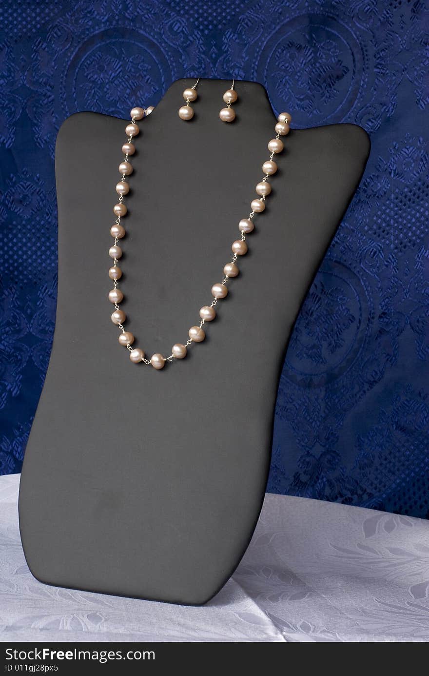 A luxury necklace on a blue background. A luxury necklace on a blue background.