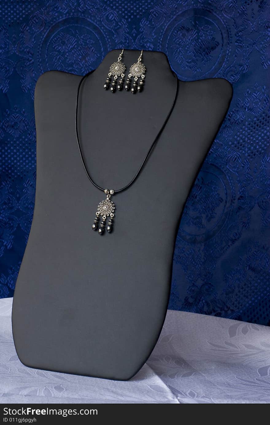 A luxury necklace on a blue background. A luxury necklace on a blue background.