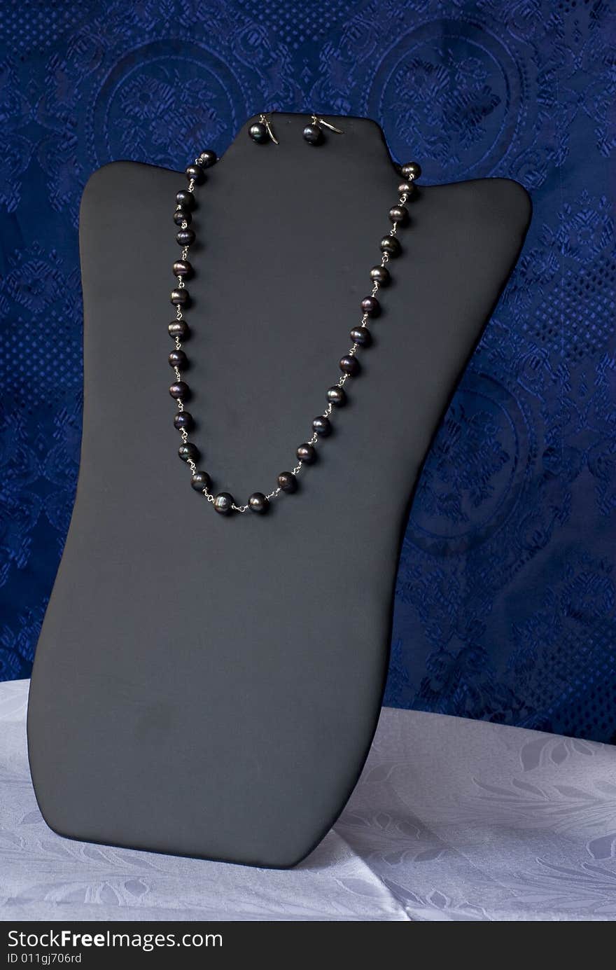 A luxury necklace on a blue background. A luxury necklace on a blue background.