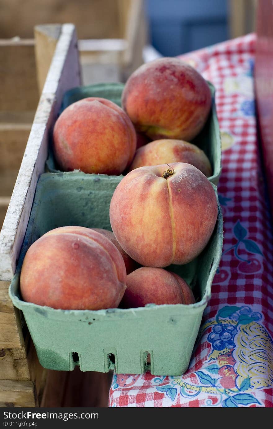 Beautiful peaches outside on a summer day.