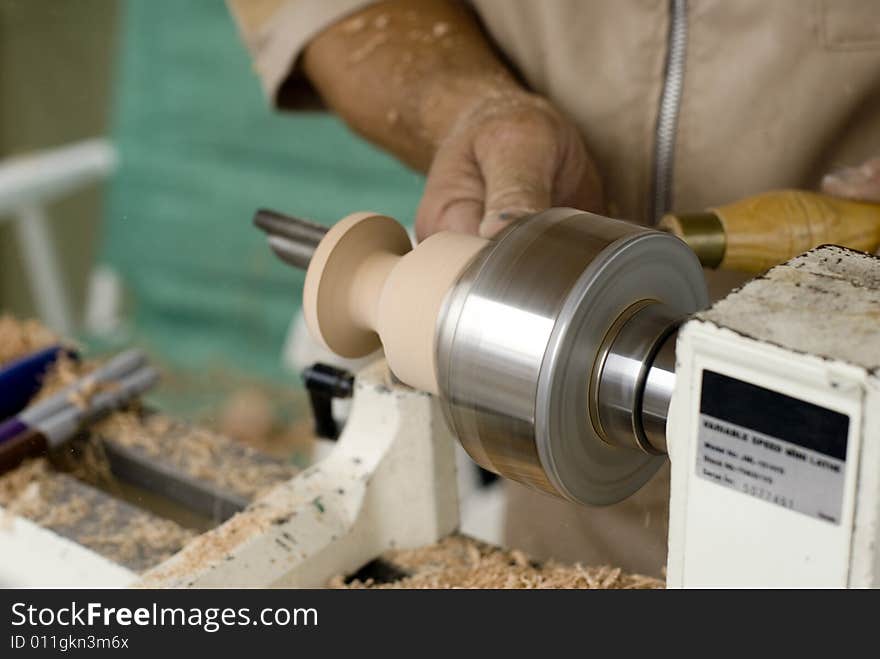 A man carving a piece of artwork. A man carving a piece of artwork.