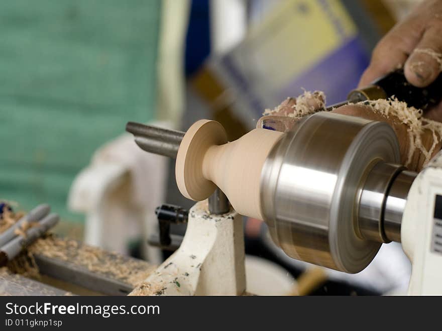 A man carving a piece of artwork. A man carving a piece of artwork.