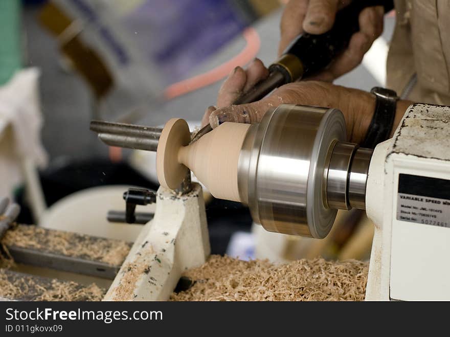 A man carving a piece of artwork. A man carving a piece of artwork.