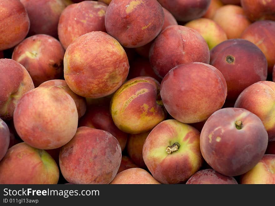 Beautiful peaches outside on a summer day.