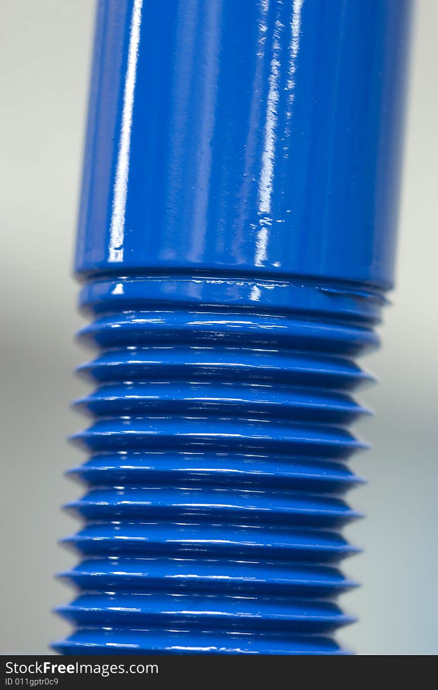 Close-up of shiny, blue bolt. Very shallow depth of field.