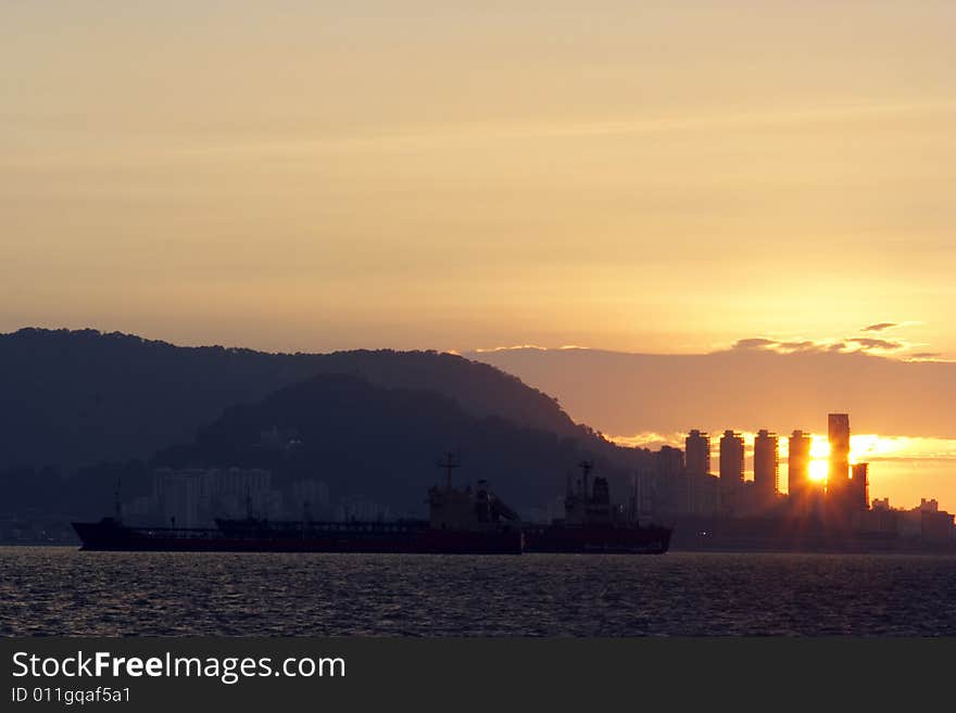 Sunset at harbour near city