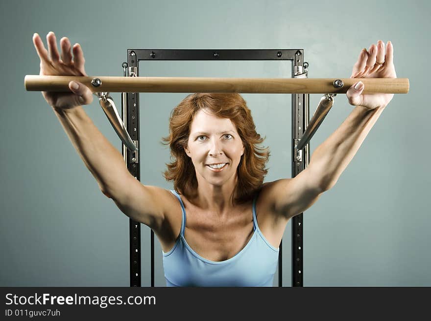 Woman using gym equipment to do a strength workout. Woman using gym equipment to do a strength workout