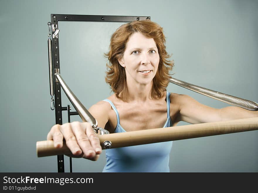 Woman using gym equipment to do a strength workout. Woman using gym equipment to do a strength workout