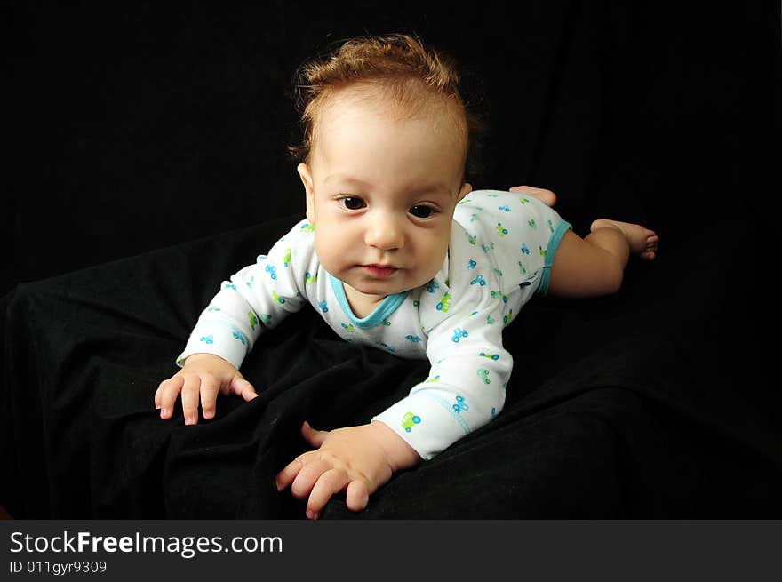 Baby boy isolated over black