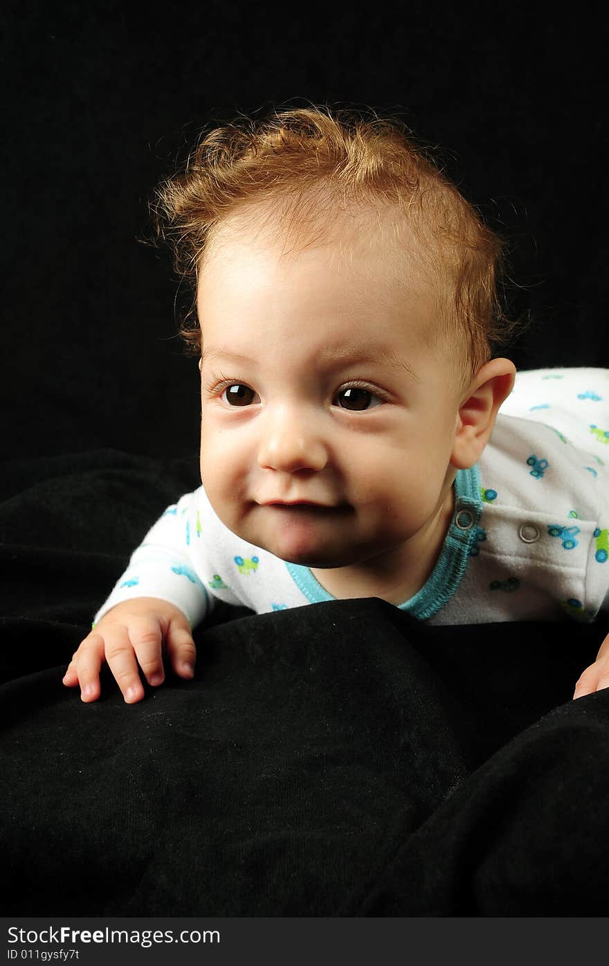 Baby boy isolated over black