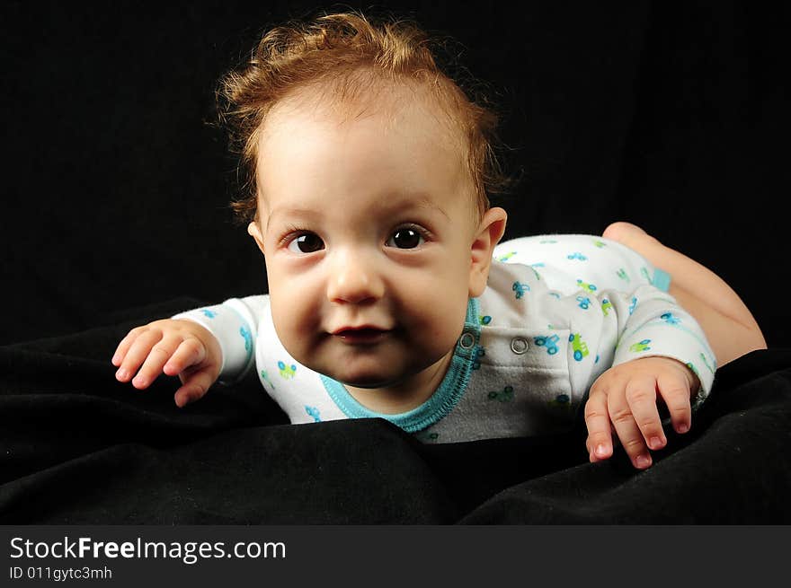 Baby boy isolated over black