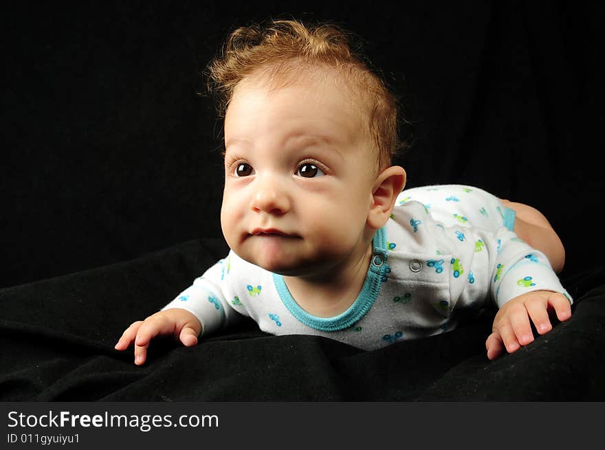 Baby boy isolated over black