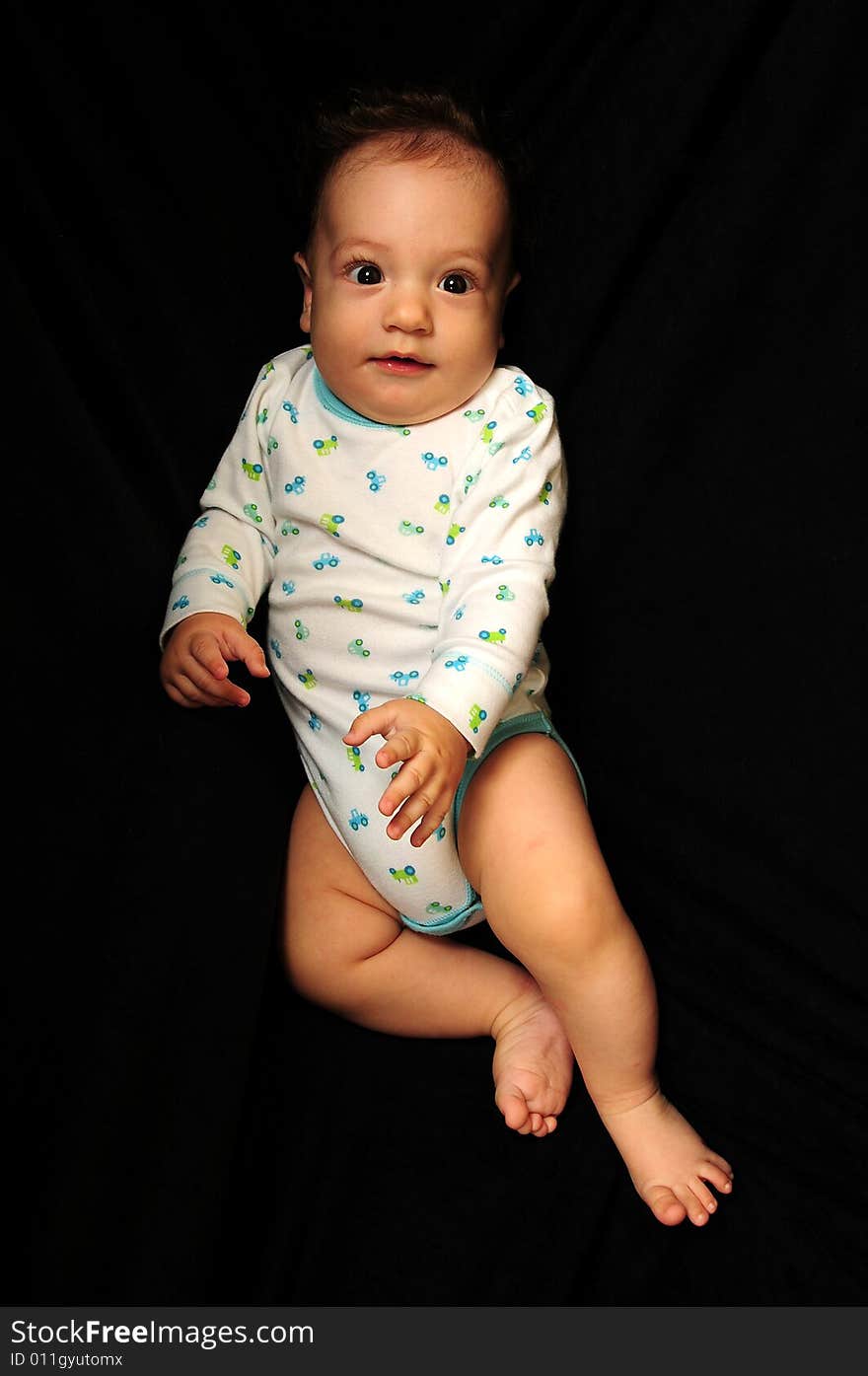 Baby boy isolated over black