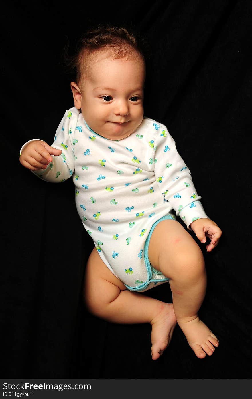 Baby boy isolated over black