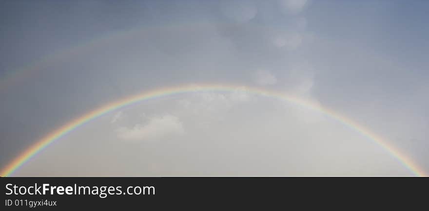 Beutiful double rainbow on blue sky