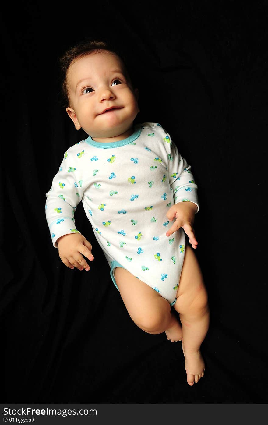 Baby boy isolated over black