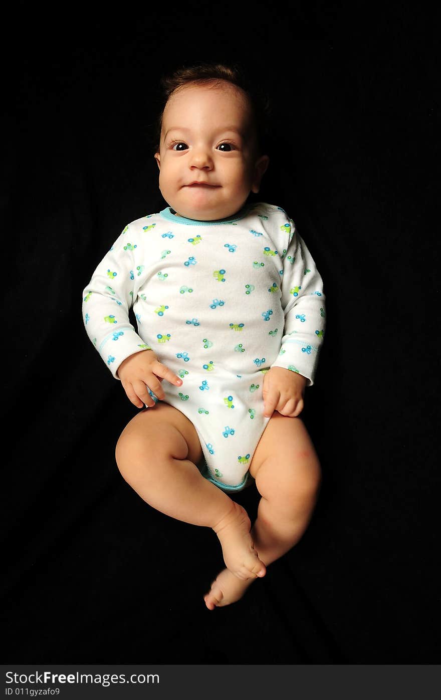 Baby boy isolated over black