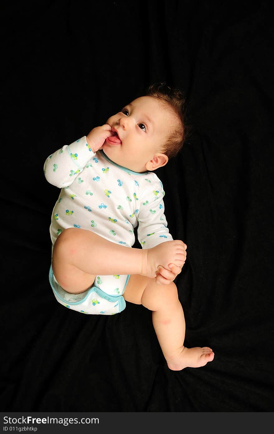 Baby boy isolated over black