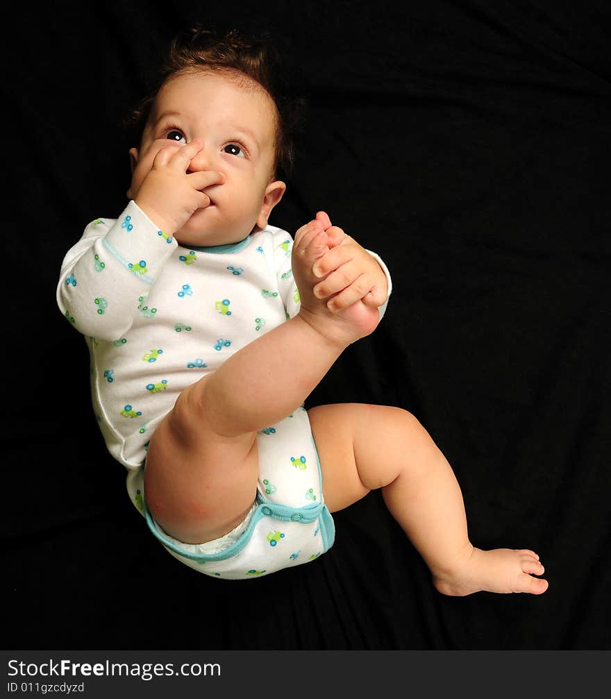 Baby boy isolated over black