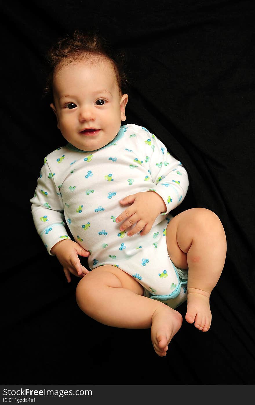 Baby boy isolated over black