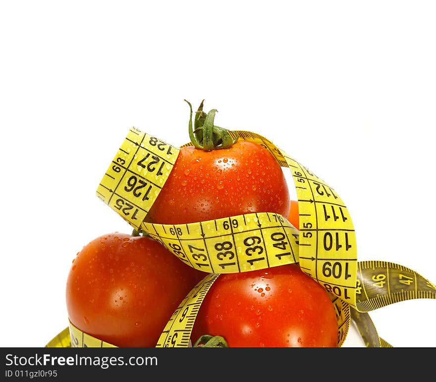 Ripe juicy tomatos and tape measure isolated