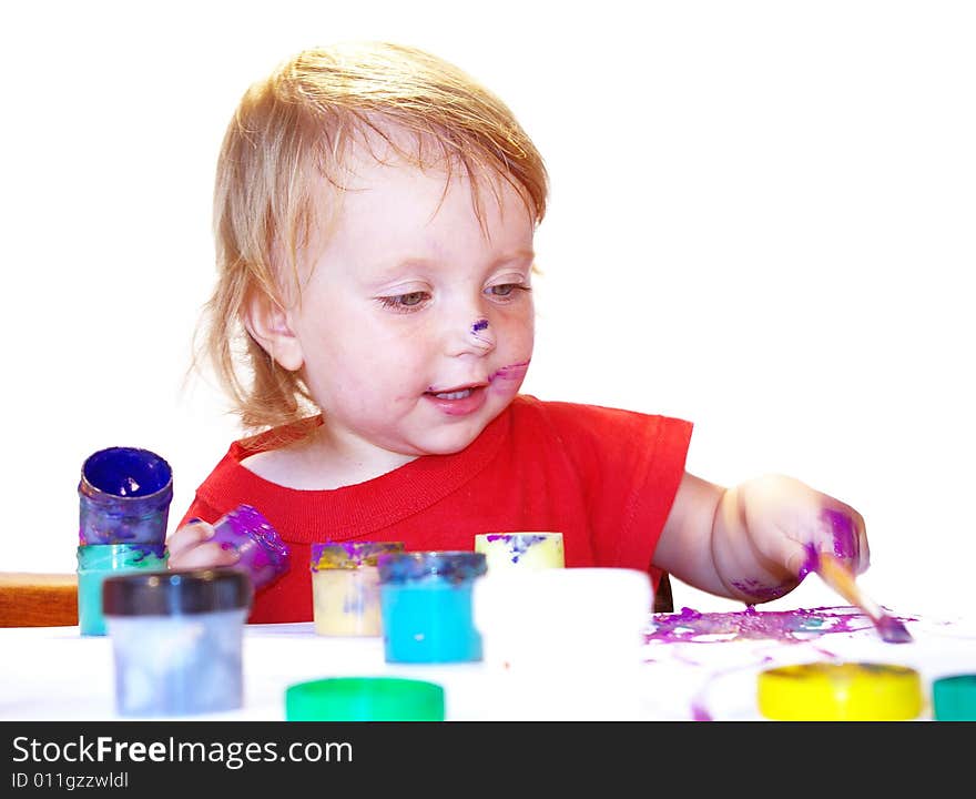 Little girl draws on a table isolated. Little girl draws on a table isolated