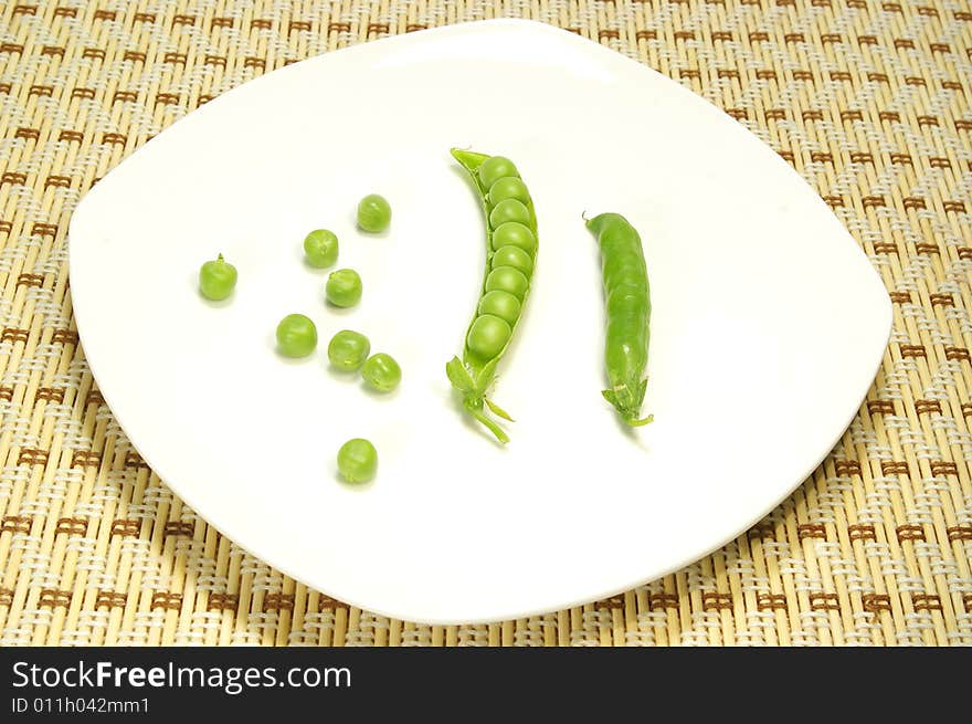 Ripe pea isolated on a white plate. Ripe pea isolated on a white plate