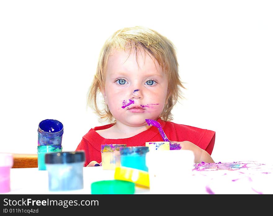 Little girl draws on a table isolated. Little girl draws on a table isolated