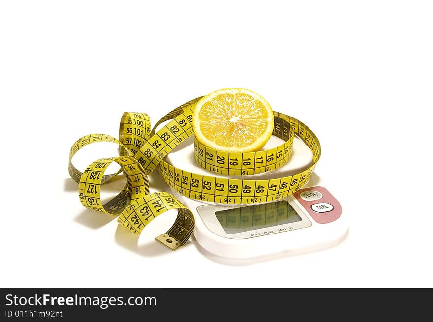 Lemon and tape measure on the scale