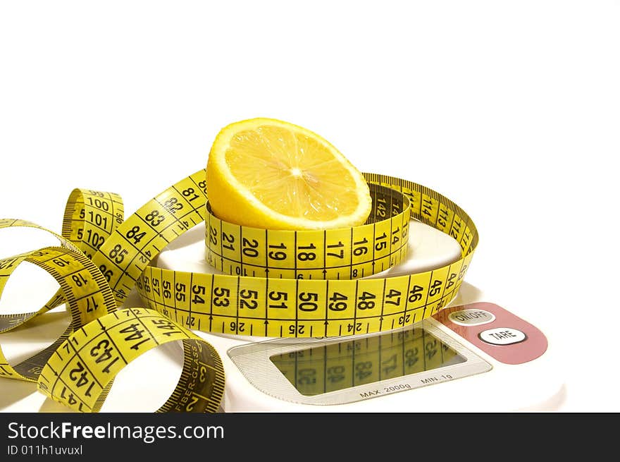 Lemon and tape measure on scale isolated. Lemon and tape measure on scale isolated