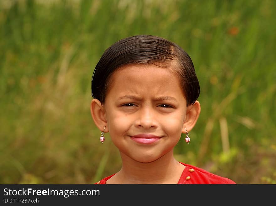 A playful and bright face of a small girl. A playful and bright face of a small girl.