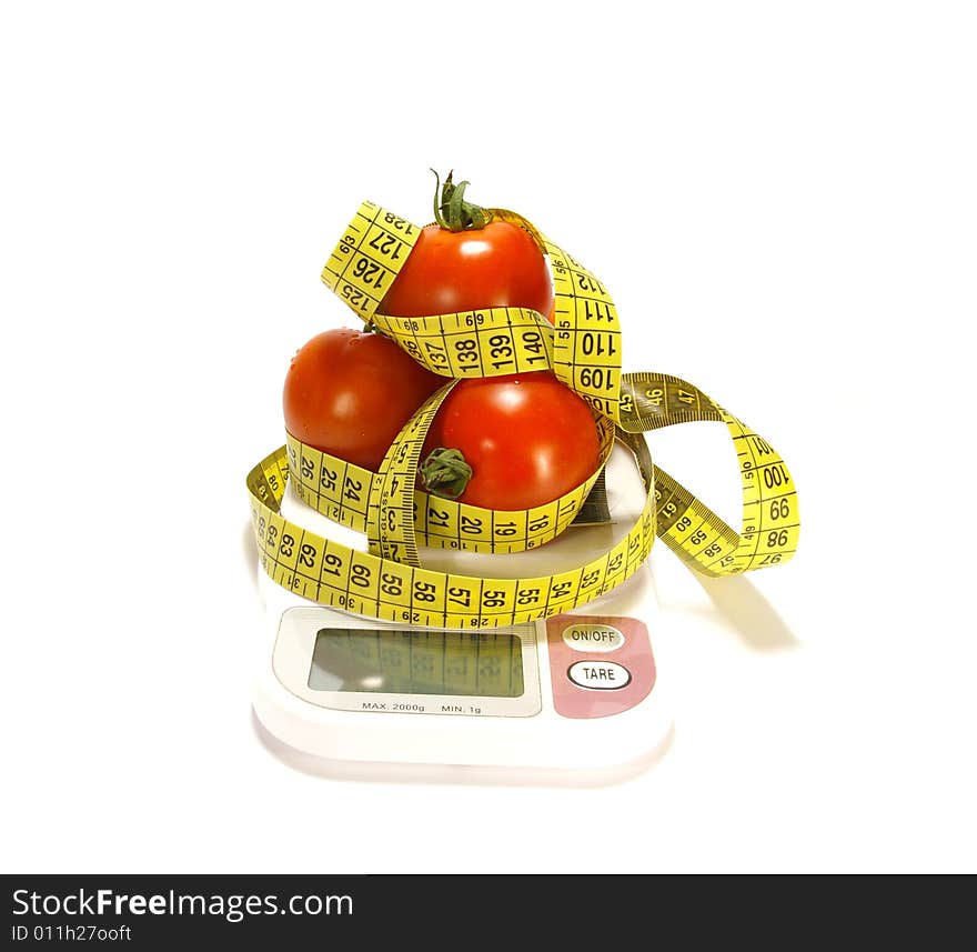 Ripe juicy tomatos and tape measure isolated