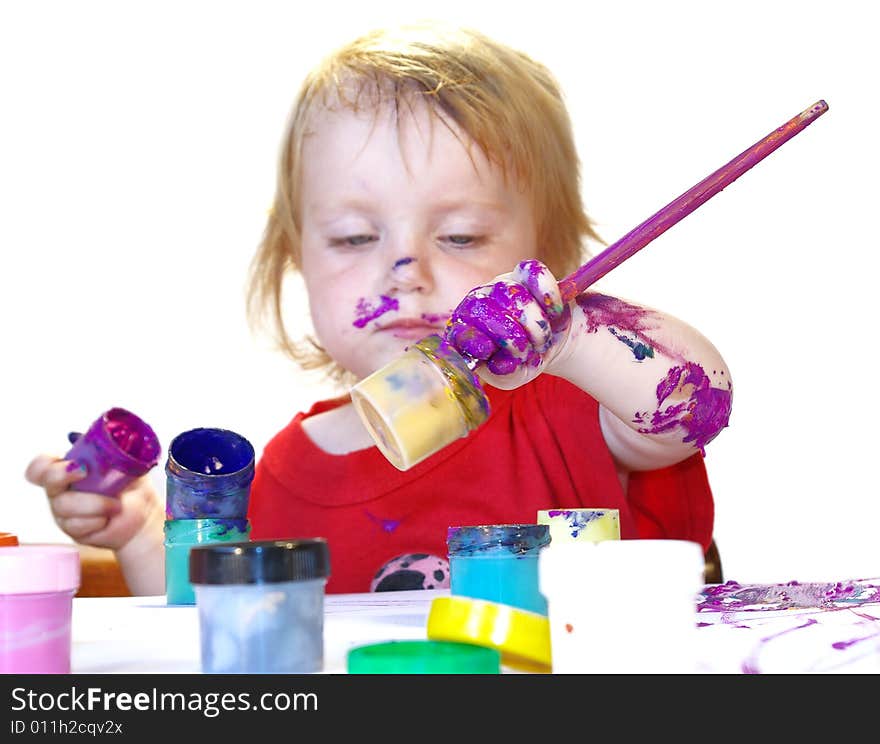 Little girl draws on a table isolated. Little girl draws on a table isolated