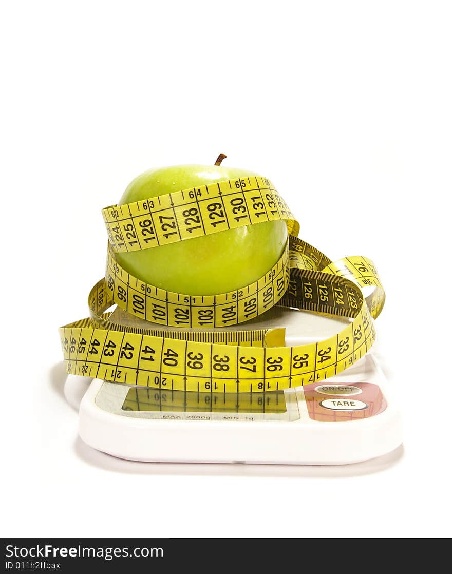 Green apple, scale and tape measure isolared. Green apple, scale and tape measure isolared