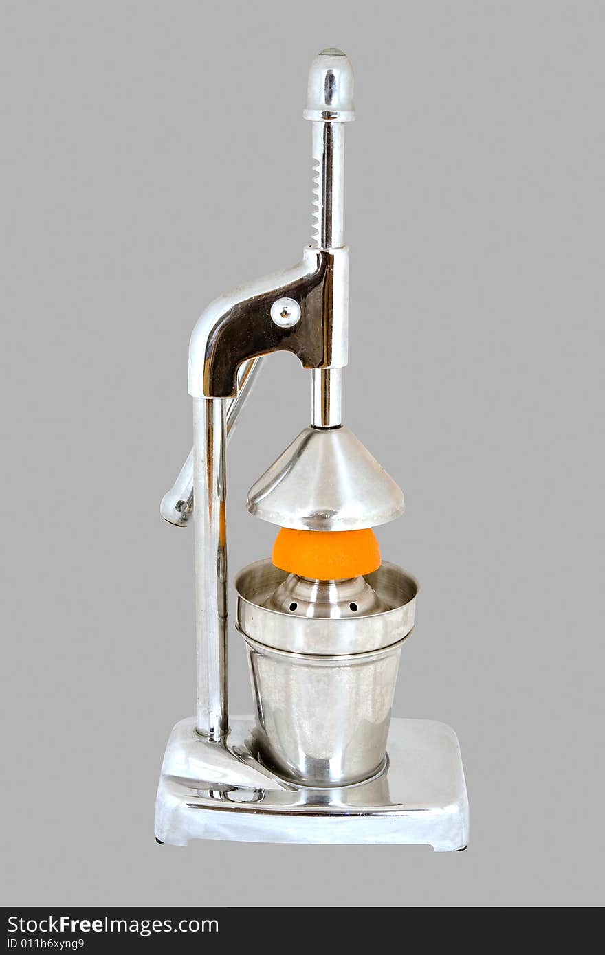 Hand juicer with orange on grey background