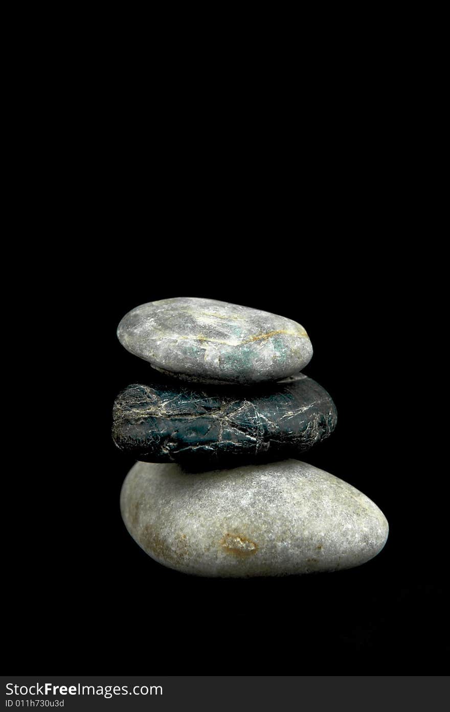 River rocks isolated against a black background