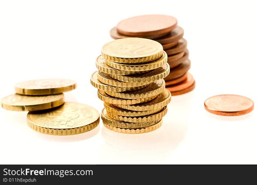 Piles of european coins over white. Shallow DOF